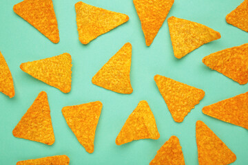 Corn chips nachos on mint background, top view