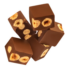 Chocolate explotion. Flying Cubes of milk chocolate bar with hazelnuts isolated on white background. .