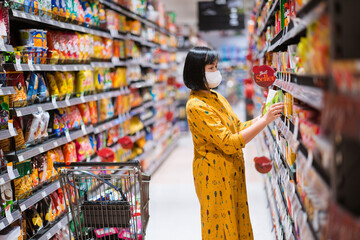 Portrait of a Woman shopping in the supermarket.