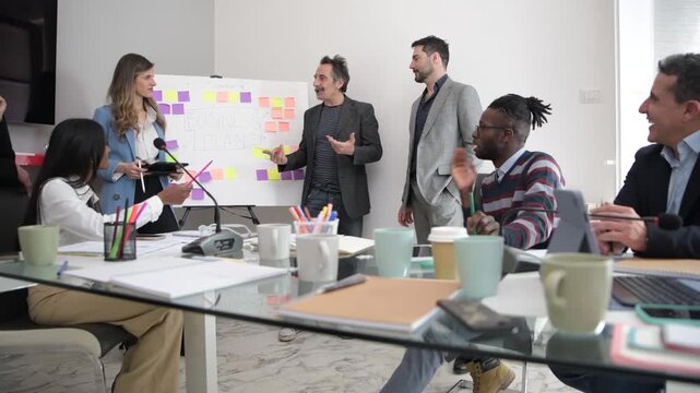 Multiracial group of colleagues in discussion during business meeting &ndash; multicultural business people at table &ndash; diverse successful business professional in corporate office
