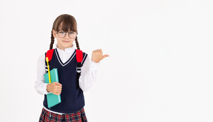 An engaged teen girl looks excited, pointing right, with notebook and yellow pen getting an idea,...