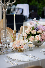 Elegant Wedding Reception Decor with Pastel Floral Arrangements and Crystal Chandeliers