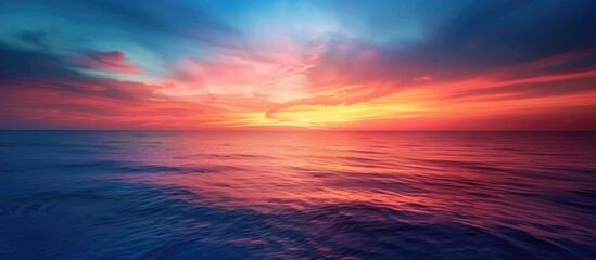 A striking photo of a blue and orange sky captured over the sea is featured as a backdrop in this copy space image