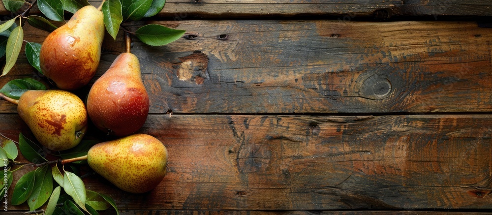Poster Pears with leaves arranged on a wooden table with copy space image