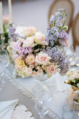 Elegant Wedding Reception Decor with Pastel Floral Arrangements and Crystal Chandeliers