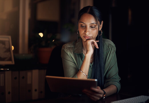 Reading, woman and tablet at night for research, business and review in workplace. Overtime, blog and online or proposal for report, feedback and news in office with email, website and media at desk