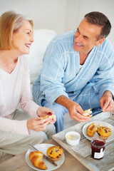 Senior couple, bedroom and food for romance, breakfast and wellness for retirement health. Mature woman, man and croissant or muffin for meal with fruit jam for diet, nutrition and care for support