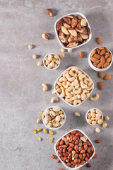 Healthy mix nuts on wooden background. Almonds, hazelnuts, cashews, peanuts, pistachios, Brazil nuts