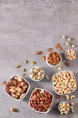Healthy mix nuts on wooden background. Almonds, hazelnuts, cashews, peanuts, pistachios, Brazil nuts