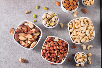 Healthy mix nuts on wooden background. Almonds, hazelnuts, cashews, peanuts, pistachios, Brazil nuts