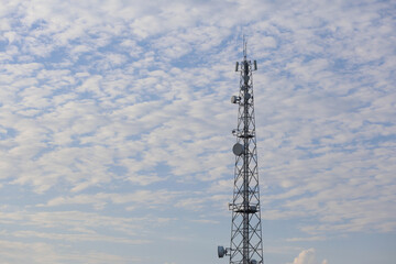 cell phone tower against cloudy sky