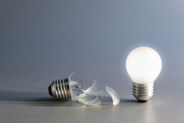 Comparative a broken and a glowing light bulb, old and new idea, failure and success, self...
