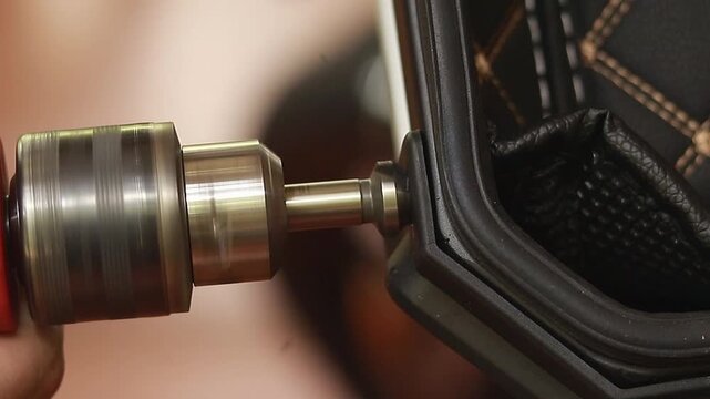 Using a tapered countersink drill bit with a handheld electric drill machine to widen a hole in a plastic casing 