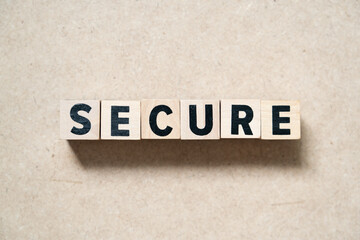 Alphabet letter block in word secure on wood background