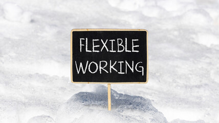 Flexible working symbol. Concept words Flexible working on beautiful yellow blackboard. Beautiful white snow background. Business flexible working concept. Copy space.