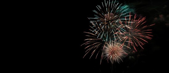 Colorful fireworks illuminating the night sky with a mesmerizing display creating a stunning visual effect against a dark background in a copy space image