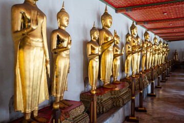 Row of Golden Buddha at Wat Pho, Bangkok Thailand.