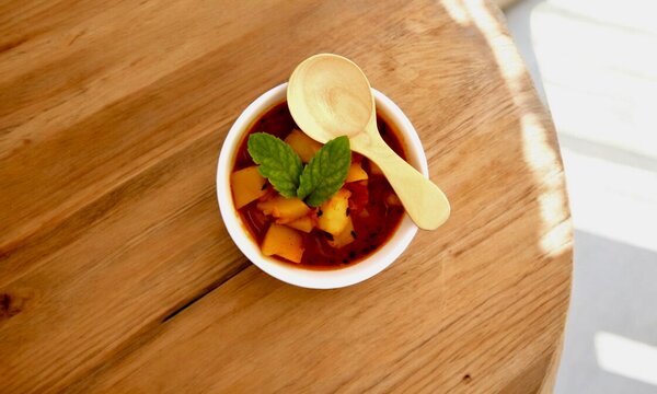 Potato soup in bowl over wooden background. Top view, flat lay