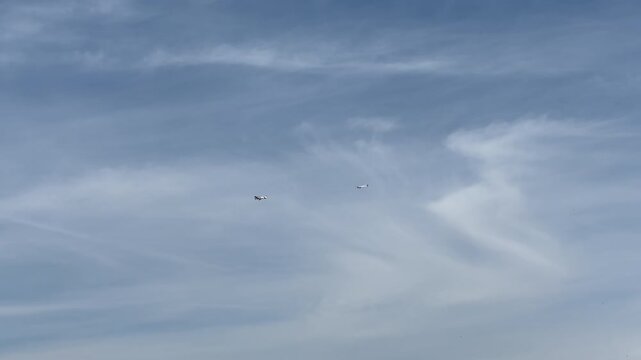 small passenger plane in flight tows a glider in the blue sky. High quality 4k footage
