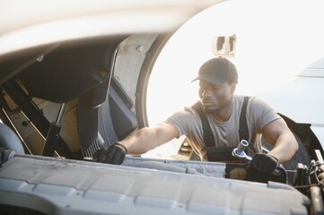 Repairing Broken Semi Truck Tractor Engine. African american Trucks Mechanic