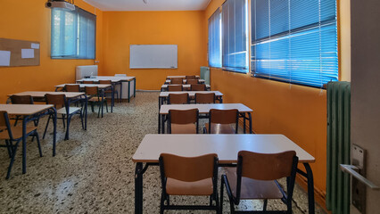 class of elemantary school desk chairs board empty