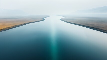 A serene river flowing through a misty landscape, showcasing calm waters and tranquil surroundings.