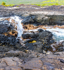 Water Rushing Over The Lava Sinks and Cliffs at Hokulia Shoreline Park, Hawaii Island, Hawaii, USA