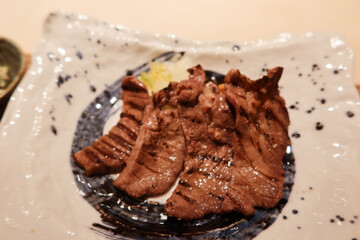 close up of Japanese grilled ox beef tongue on a white plate