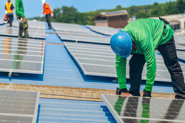 Worker Technicians are working to construct solar panels system on roof. Installing solar photovoltaic panel system. Men technicians walking on roof structure to check photovoltaic solar modules.