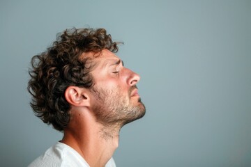 Fototapeta premium Portrait of a Stressed Man in Profile View Expressing Mental Health Struggles