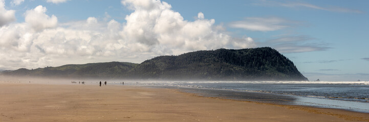 Misty Ocean Beach with Mountain View and People