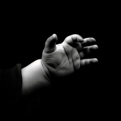 "Touch of Innocence: A Child's Hand Close-Up"