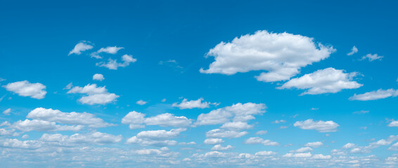 Panoramic background of perfect blue sky with beautiful cumulus clouds