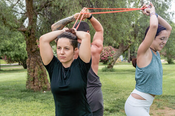 Group of friends exercising with resistance bands outdoors