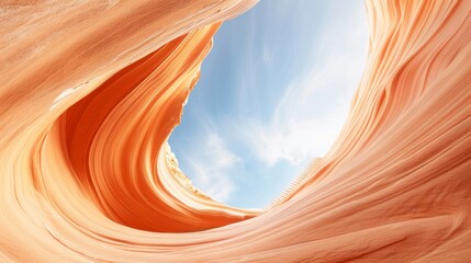 Stunning view of sandstone canyon walls framing a bright blue sky. Nature's artistry in vibrant orange and soft texture.