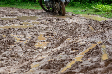 Muddy, dirt road in the rainy season in rural Thailand.