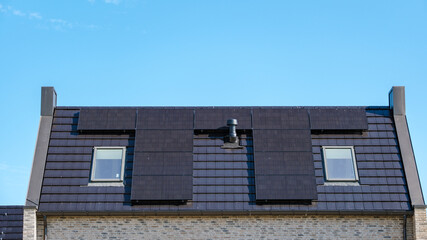 Sleek Solar Panels Harnessing Sun Energy on a Modern Roof in Clear Blue Sky