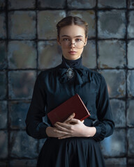 Portrait of a teacher of the past with a book