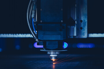 Laser CNC cut of metal with light spark. Blue color background banner, technology modern industrial