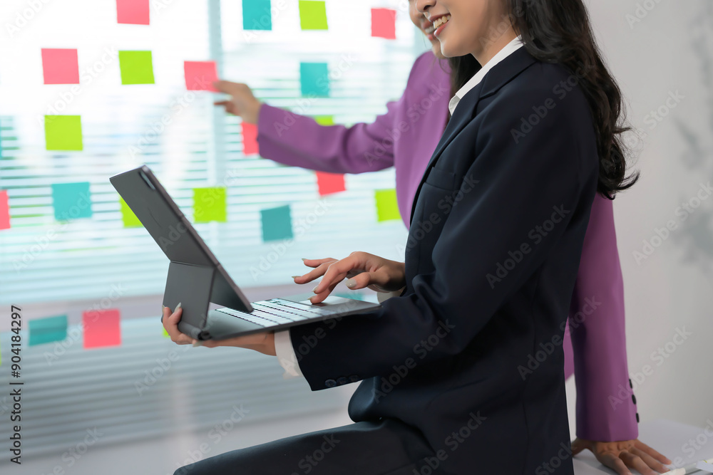 Poster business professionals collaborating with digital tablet and sticky notes in modern office setting