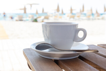 Cup of Coffee on Table by the Beach