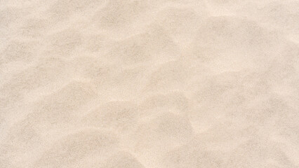 Sand ripple texture top view, Empty rough dry brown sand beach shore background, Grain pattern yellow sand dune in summer  
