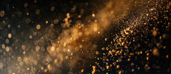 Fototapeta premium Sawdust dropping onto a black backdrop with room for writing in the copy space image