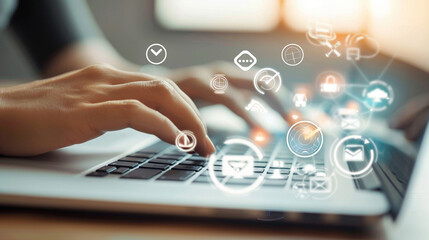 Closeup of hands using a laptop with digital icons for various learning tools floating around