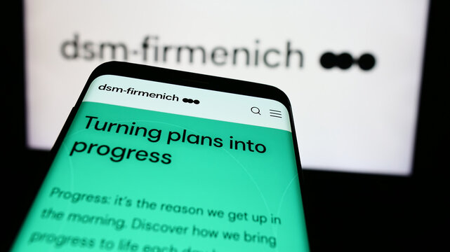 Stuttgart, Germany - 07-21-2024: Mobile phone with website of Swiss chemicals company DSM-Firmenich AG in front of business logo. Focus on top-left of phone display.