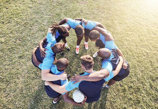 Rugby, men and huddle of team with fitness, motivation and pride in competitive game. Collaboration, sports and teamwork, diverse players ready for match, workout or tournament above field at club