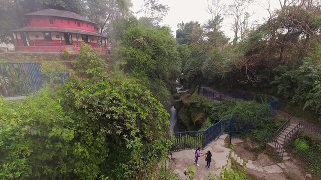 Time lapse tourist visit Devi's Fall - waterfall located at Pokhara in Kaski District, Nepal. The water forms a tunnel after reaching the bottom. Nature hidden gem in Pokahra
