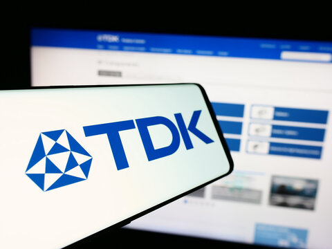 Stuttgart, Germany - 07-23-2024: Smartphone with logo of Japanese electronics company TDK Corporation in front of business website. Focus on center-left of phone display.