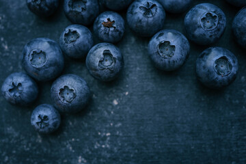 Blueberries background. Blueberry border design. Ripe and juicy fresh picked bilberries close up. Copyspace for your text