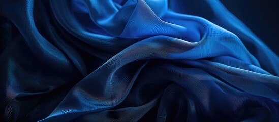 Obraz premium A mysterious blue fabric against a dark background evokes feelings of hidden secrets solitude and determination in this evocative copy space image